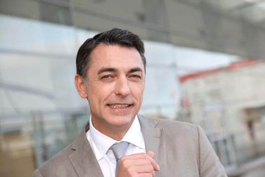 Businessman standing outside modern building