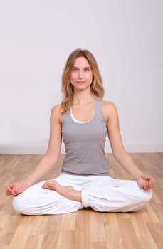 Blond woman doing yoga exercises