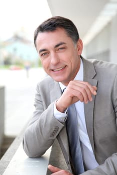 Businessman standing outside modern building