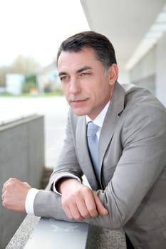 Businessman standing outside modern building