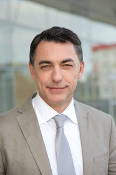 Businessman standing outside modern building