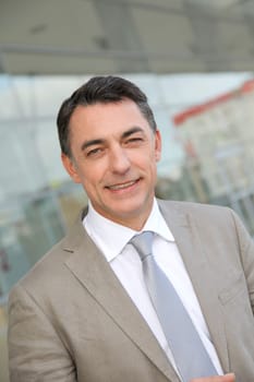 Businessman standing outside modern building