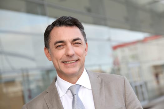 Businessman standing outside modern building
