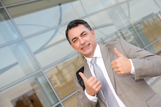 Businessman standing outside modern building