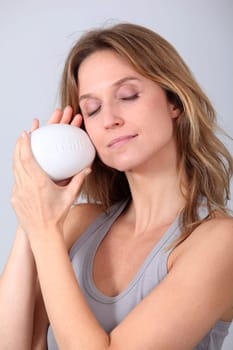 Woman holding stone with message