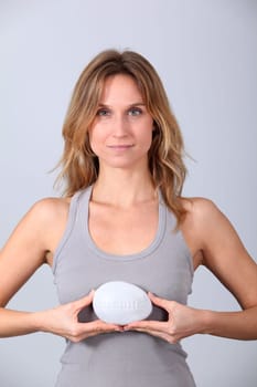 Woman holding stone with message