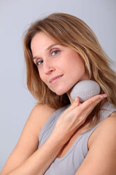 Woman holding stone with message