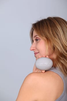 Woman holding stone with message