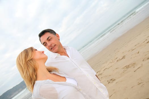 Couple walking by the beach