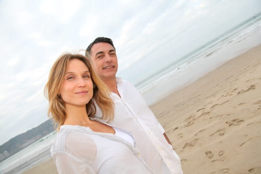 Couple walking by the beach