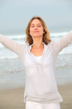 Woman breathing fresh air by the sea