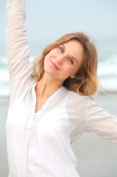 Woman breathing fresh air by the sea