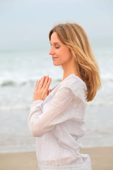 Woman breathing fresh air by the sea