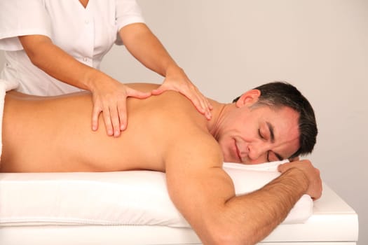 Man laying on massage bed