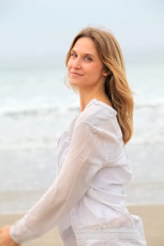 Woman breathing fresh air by the sea