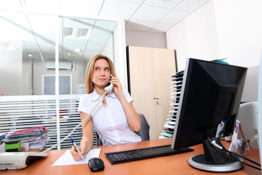 Woman talking on the phone in the office