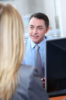 Woman meeting financial adviser in office