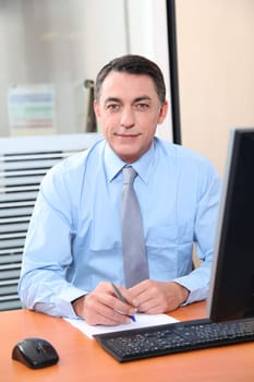Salesman working in front of computer