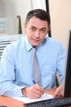 Salesman working in front of computer