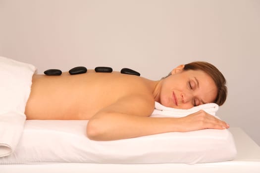 Woman having a massage with hot stones