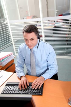 Adult man in the office talking on the phone