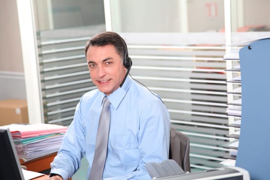 Adult man in the office talking on the phone