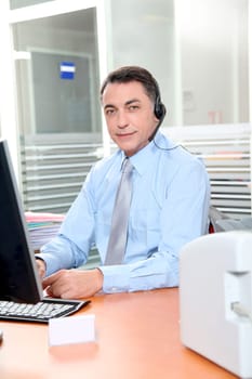 Adult man in the office talking on the phone