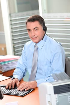 Adult man in the office talking on the phone