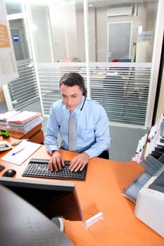 Adult man in the office talking on the phone