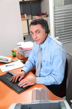 Adult man in the office talking on the phone
