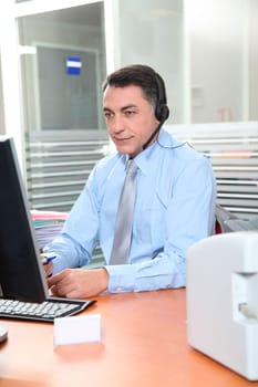 Adult man in the office talking on the phone
