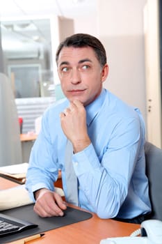 Businessman with blue shirt working in the office