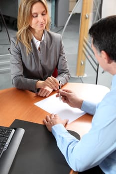 People in the office signing contract