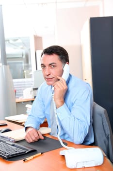 Businessman in the office talking on the phone