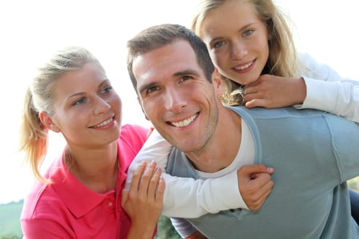 Happy family having fun in the countryside