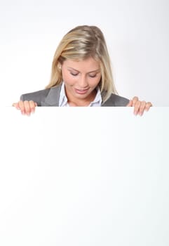 Businesswoman holding white panel