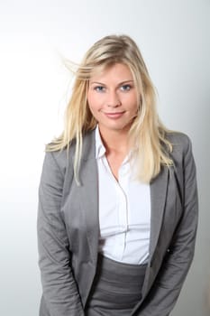 Blond businesswoman doing expressions on white background