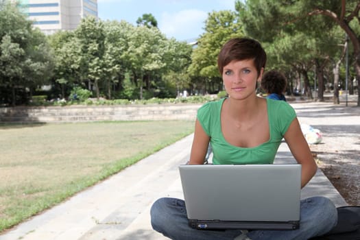 Student with laptop computer in college park