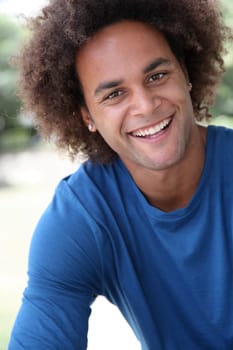 Closeup of happy young man with blue shirt