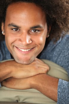 Closeup of young smiling man in couch