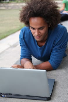 Student with laptop computer in college park