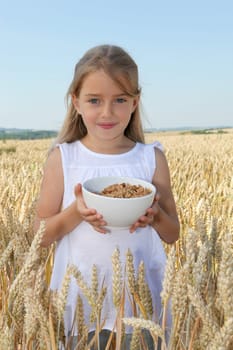 Closeup of little girl holding bowl of cereals