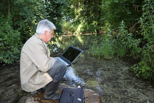 Biologist testing quality of stream water