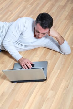 Man sitting on the floor with laptop computer