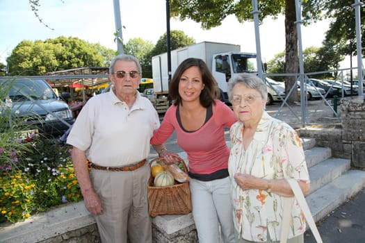Closeup of young woman with couple of elderly persons