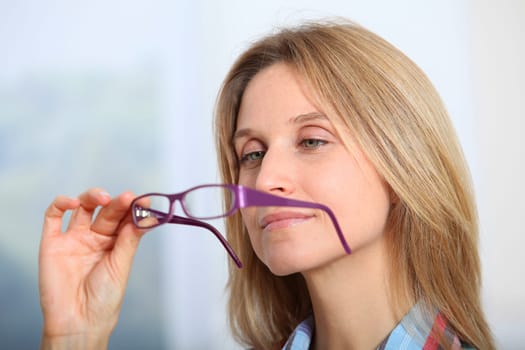 Closeup of beautiful blond woman wearing eyeglasses