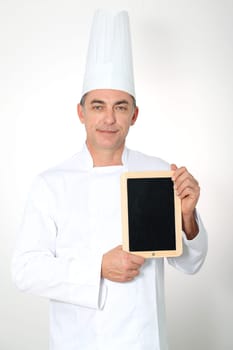 Chef holding black board for menu