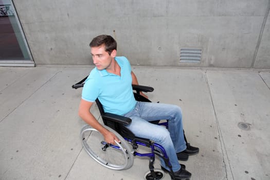 Young man using wheelchair in town