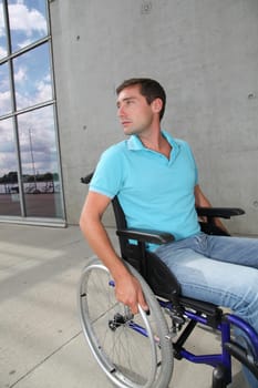 Young man using wheelchair in town