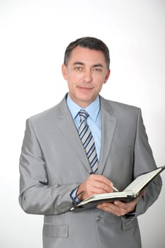 Businessman writing on agenda